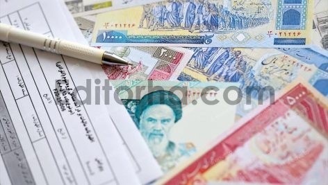 Iranian annual income tax return form F20-25-006 ready to fill on table with iranian money