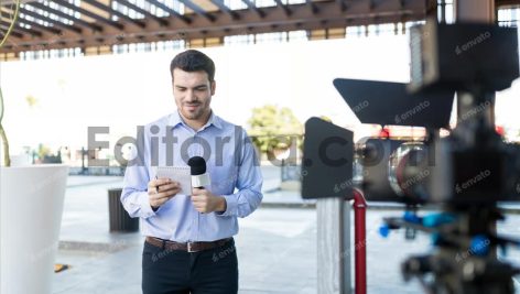 TV Reporter Reading Questions At Broadcast