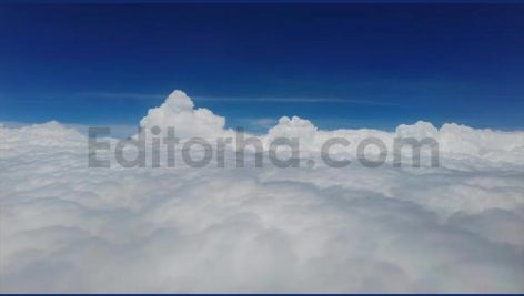 Flying above soft fluffy white cotton clouds against blue sky