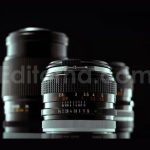 Vintage 50mm Camera Lens Spinning On Black Studio Background