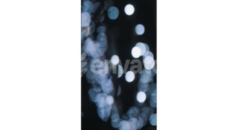 The blue garlands go out of focus. New Year's mood. Background. Bokeh.
