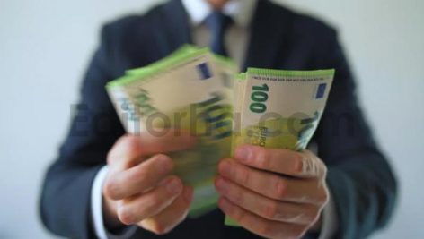 Formally Dressed Man Counting Euro Banknotes