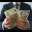 Formally Dressed Man Counting Euro Banknotes