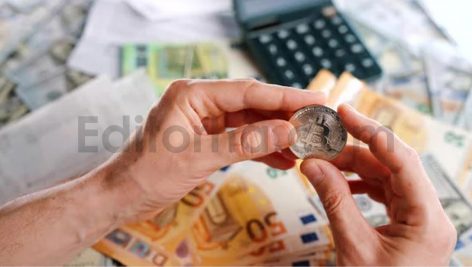 Hands Shows BTC Bitcoin Against the Dollars and Euros